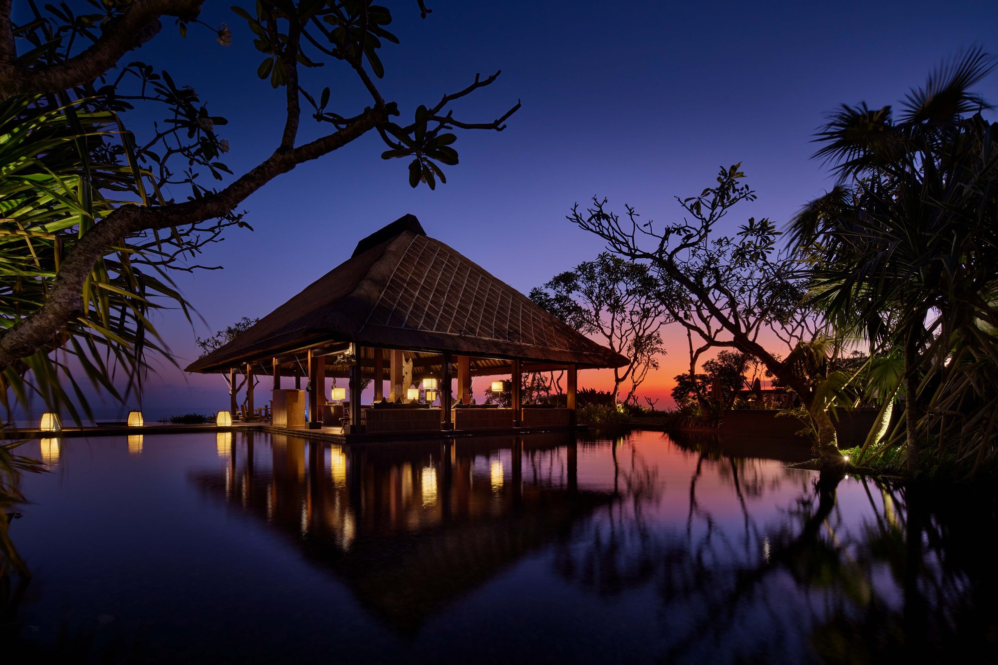 Bulgari Resort Bali — a pavilion reflected in the pool at dusk · Uluwatu, Indonesia