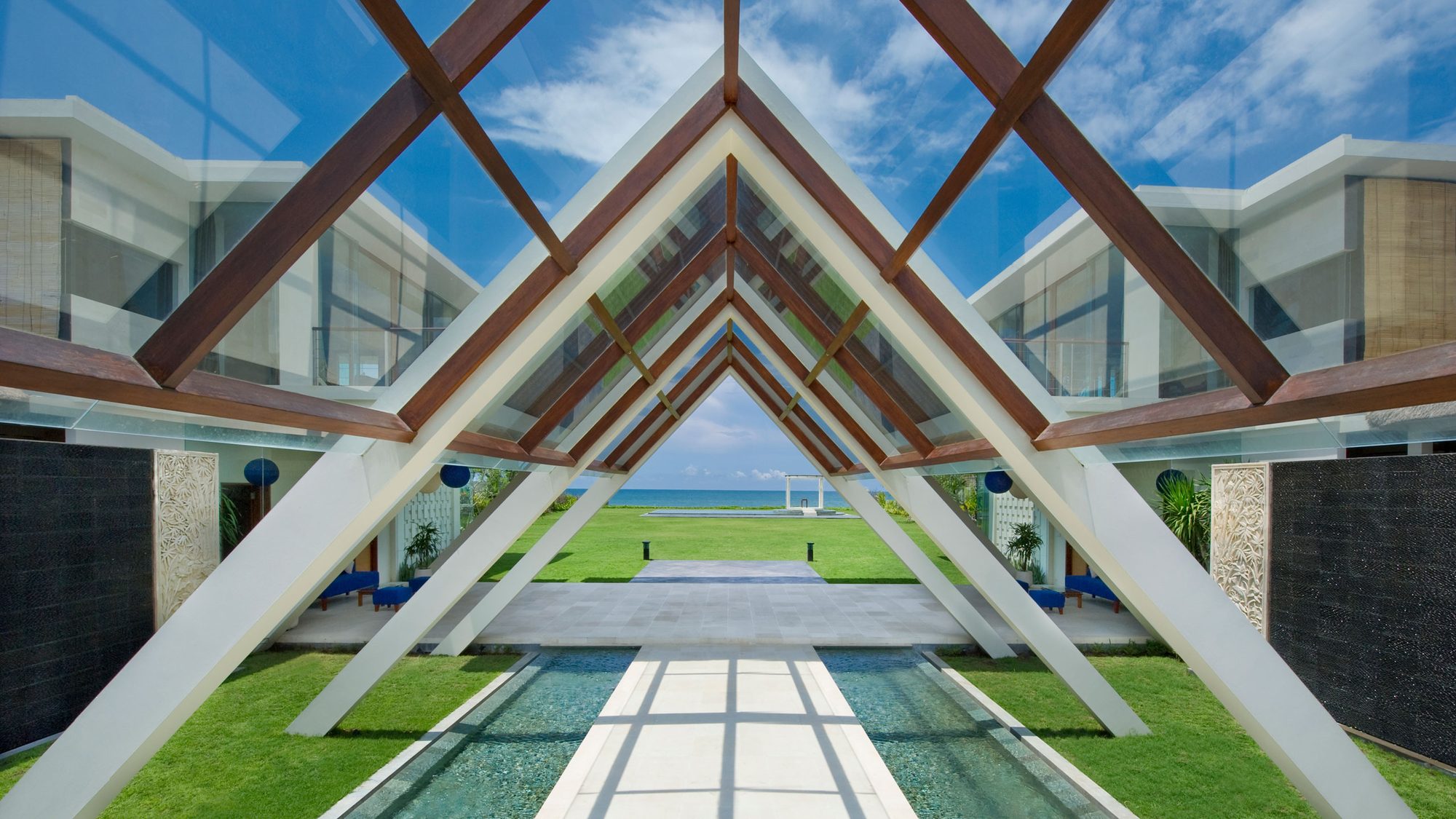 Villa Phalosa — the glass-roofed walkway leading to the lawn · Seminyak, Indonesia