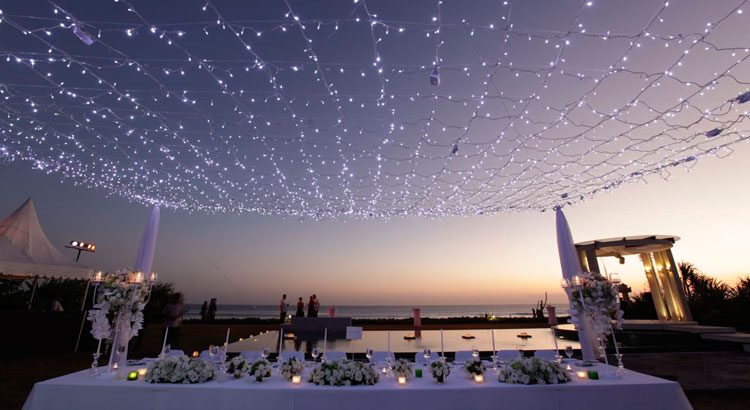 Villa Phalosa — a reception table under strings of lights at dusk · Seminyak, Indonesia